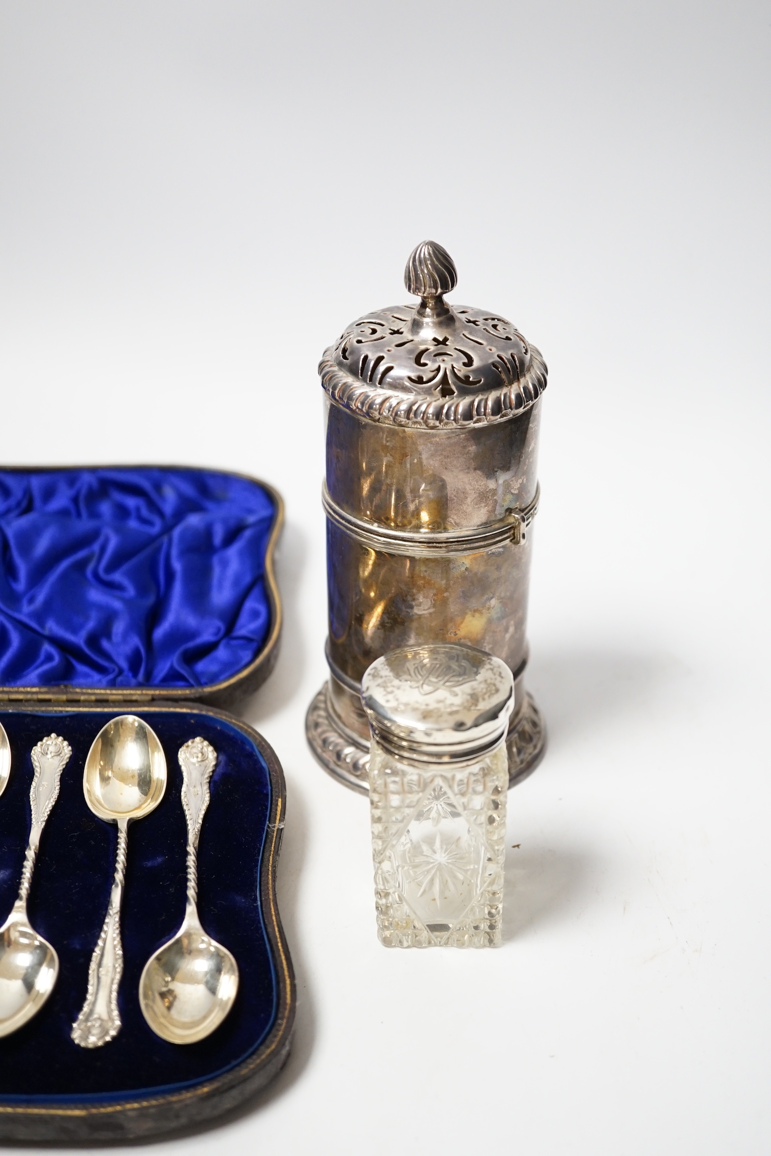 A cased set of twelve late Victorian silver teaspoons with tongs, William Hutton & Sons, London, 1898, a late Victorian silver lighthouse sugar caster, London, 1889, five assorted silver napkin rings and a silver mounted